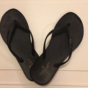 Black American Eagle flip flops